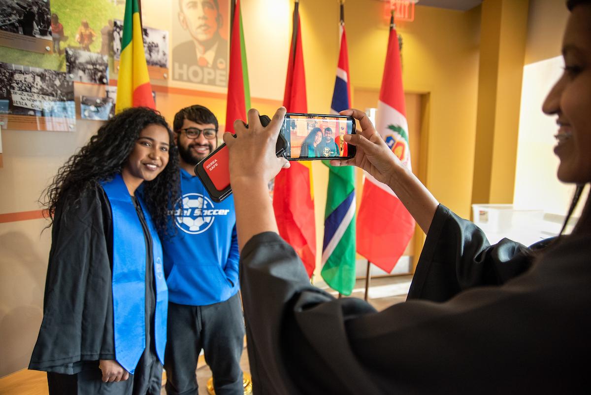 Students smiling for a picture at an International gathering in the Carter G. Woodson Center